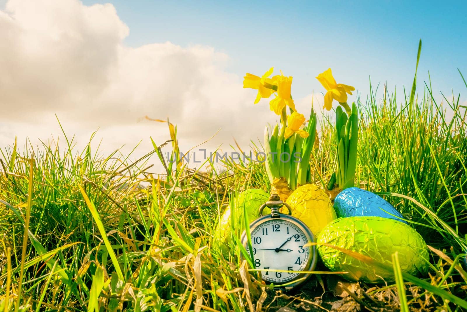 Easter eggs with daffodils and a clock
