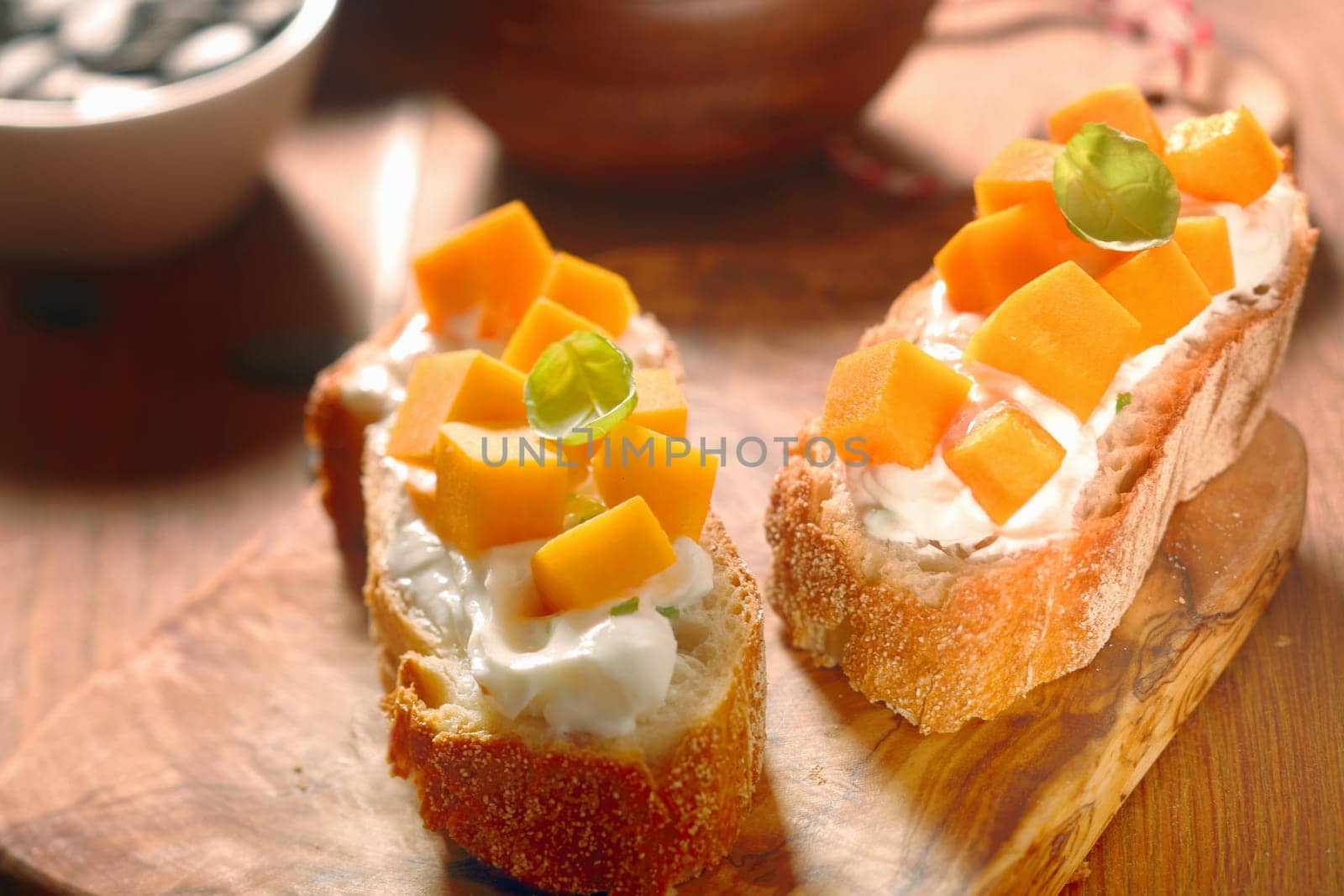 Close up Gourmet Healthy Creamed Toasted Bread with Carrot Cuts on Wooden Cutting Board.