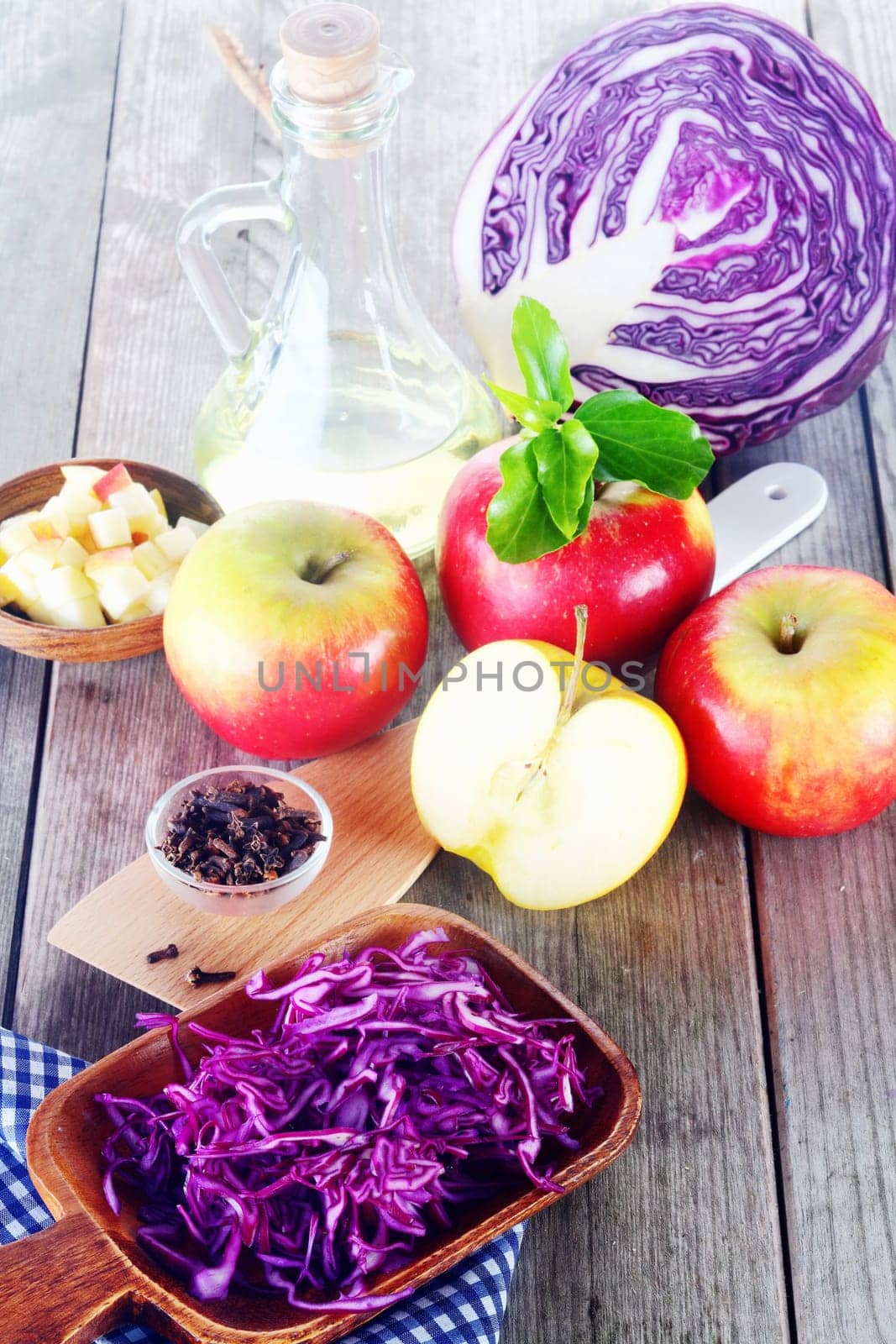 Close up Fresh Ingredients for Red Cabbage and Apple Salad on Top of Wooden Table.