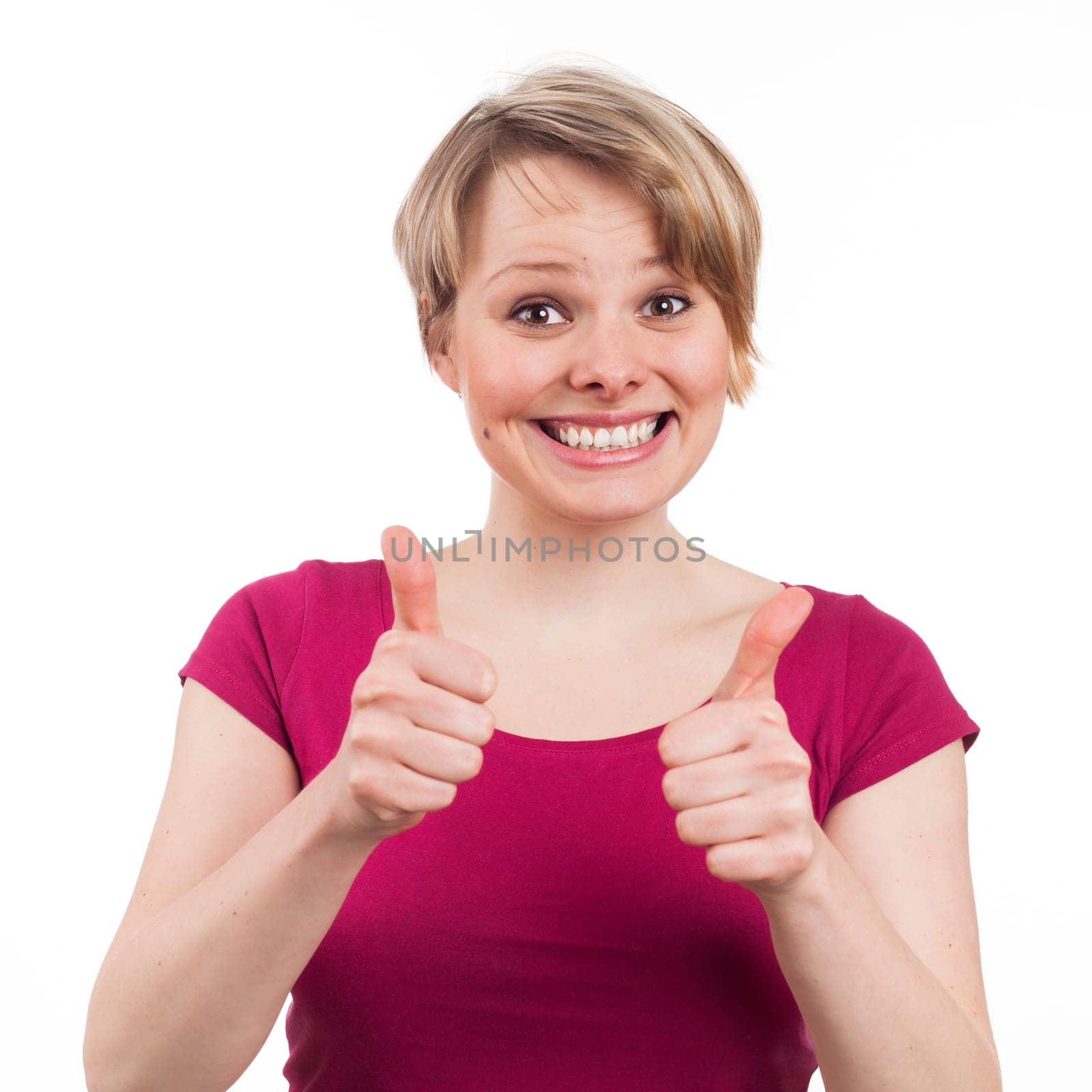 Young woman showing her thumbs up in a positive attitude, isolated on white