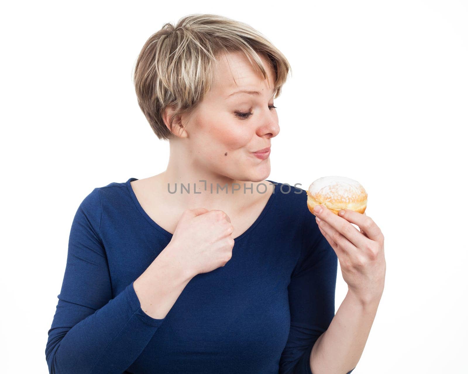 Young woman excited about a donut, isolated on white