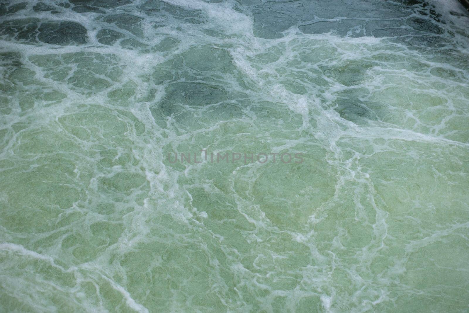 View on the textured surface of the seething river