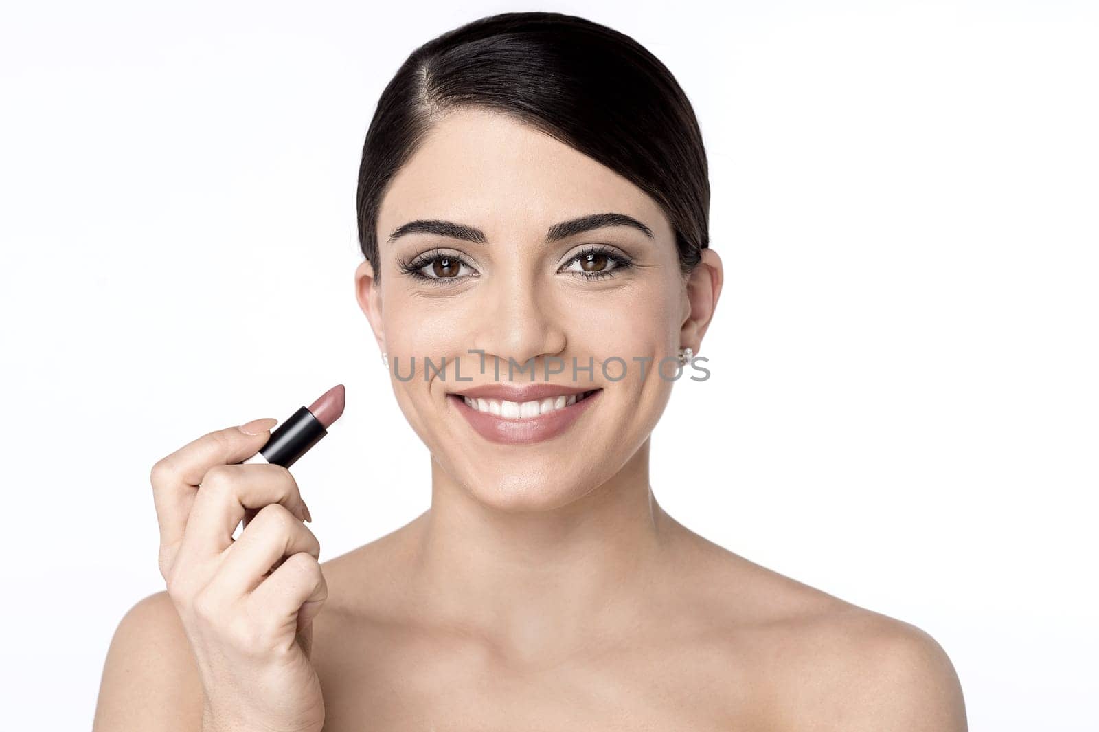 Smiling woman painting her lips with a lipstick