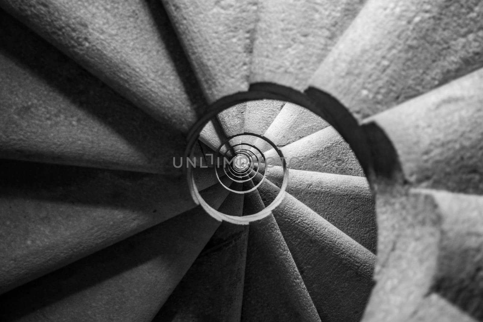 Winding and spiralling concrete staircase in a tower, with infinity point. Black and White edit