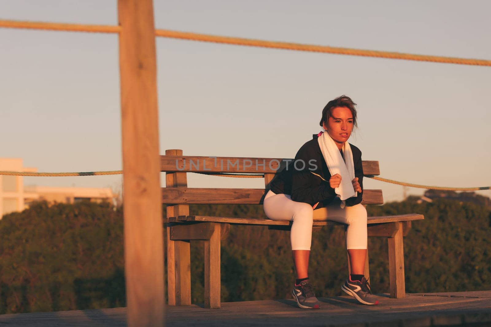 Young beautiful chinese woman exercising at the beach at sunrise/sunset