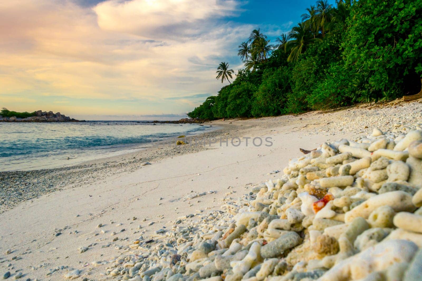 Peaceful and tropical coral turtle beach at Perhentian Islands, Malaysia, long exposure, with cloudy sky during sunset.. Postcard, mural or wallpaper about Malaysian tourism or travel