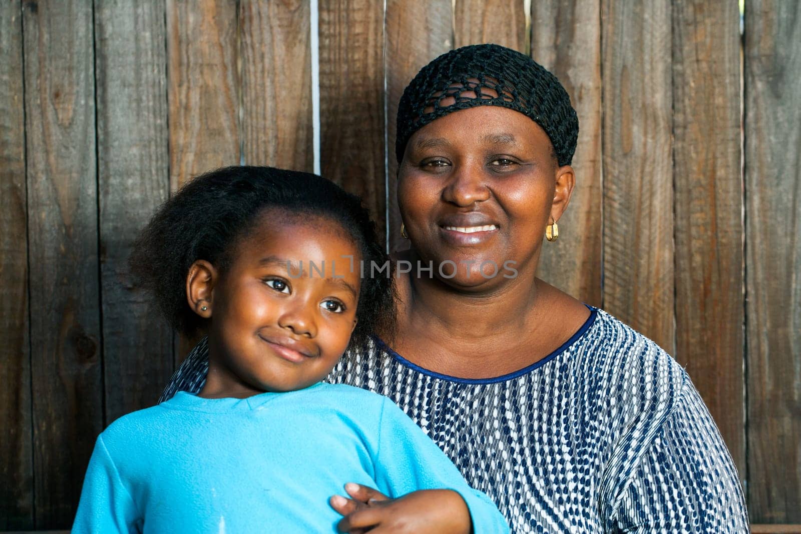 Portrait of young african mother with little daughter.