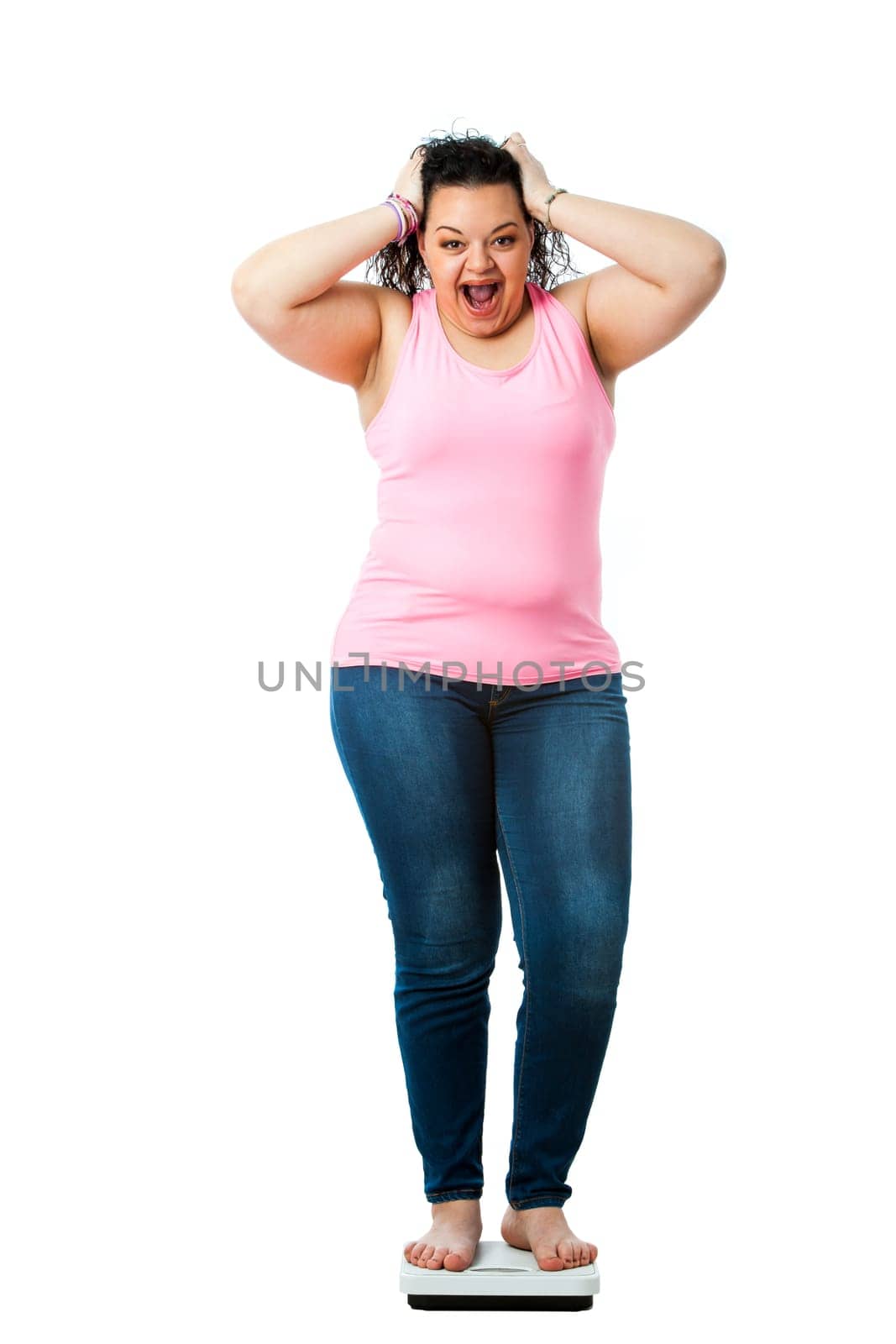 Portrait of overweight teen sanding on diet scale with shocking face expression.Isolated on white background.