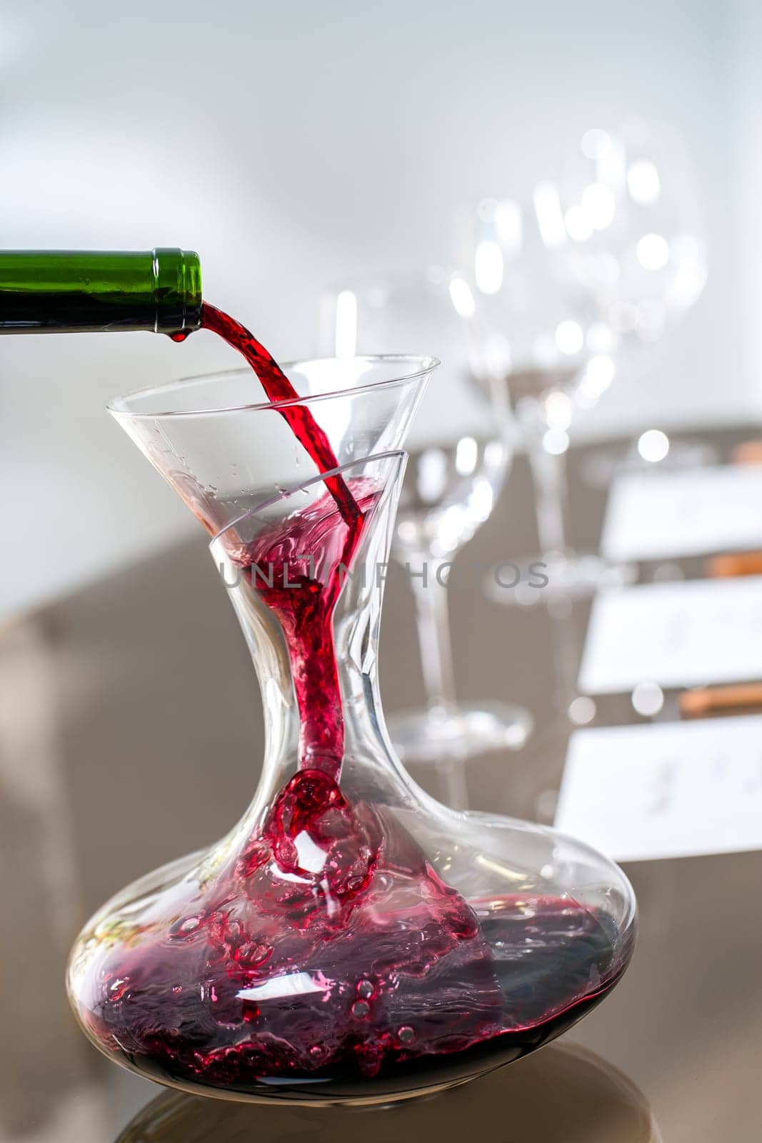 Macro close up of Red wine pouring into decanter at wine tasting.