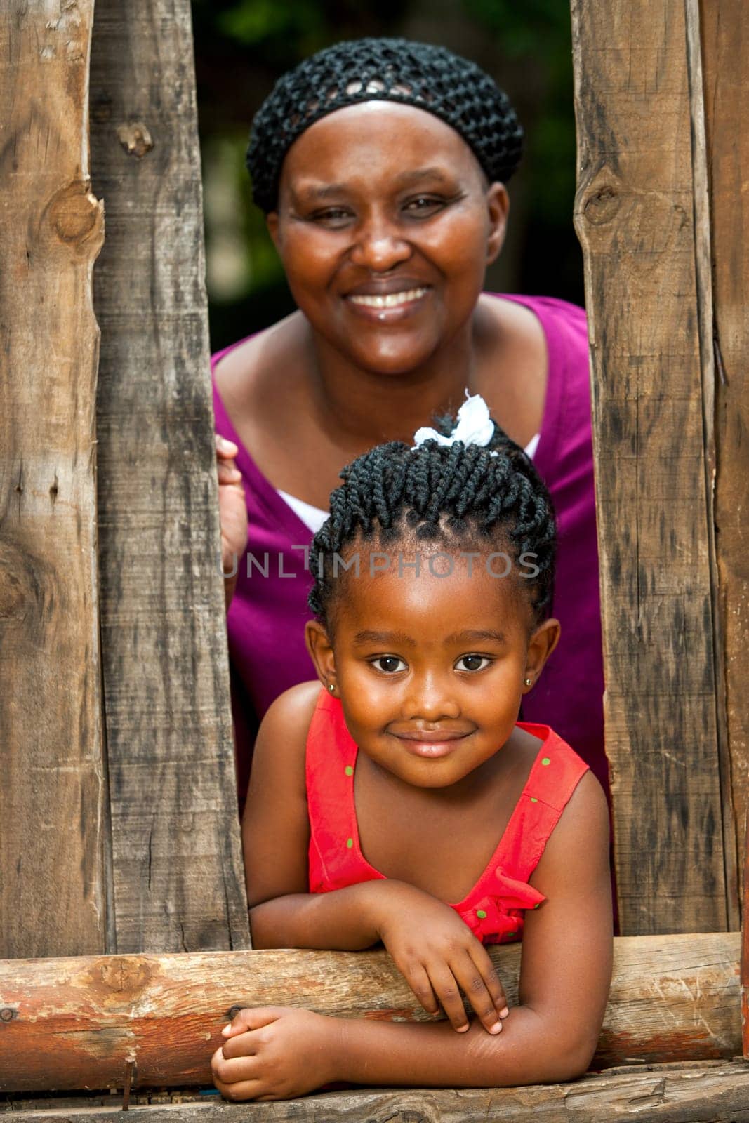 Close up family portrait of african mother with daughter outdoors.