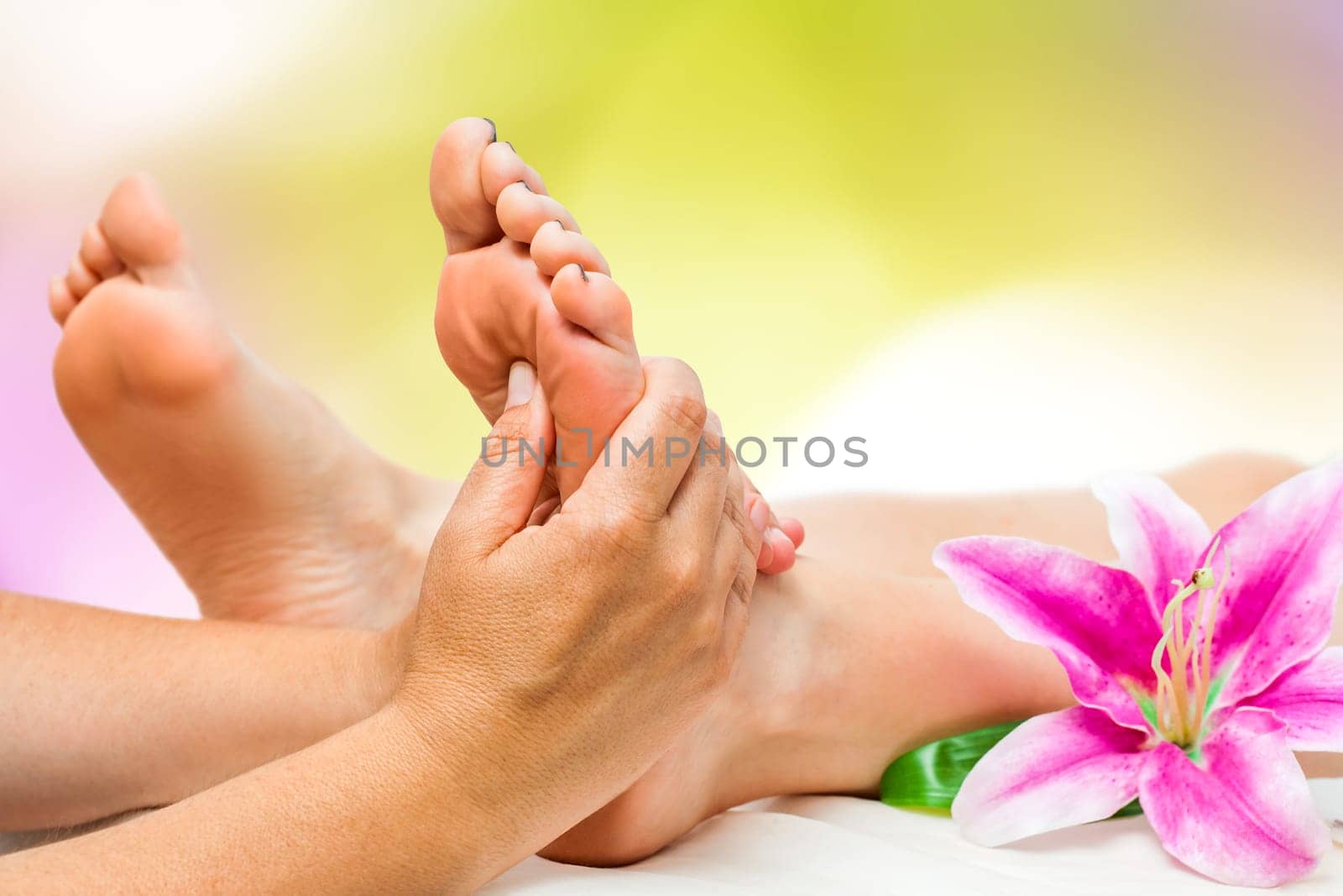 Extreme close up of female Spa therapist doing foot massage.
