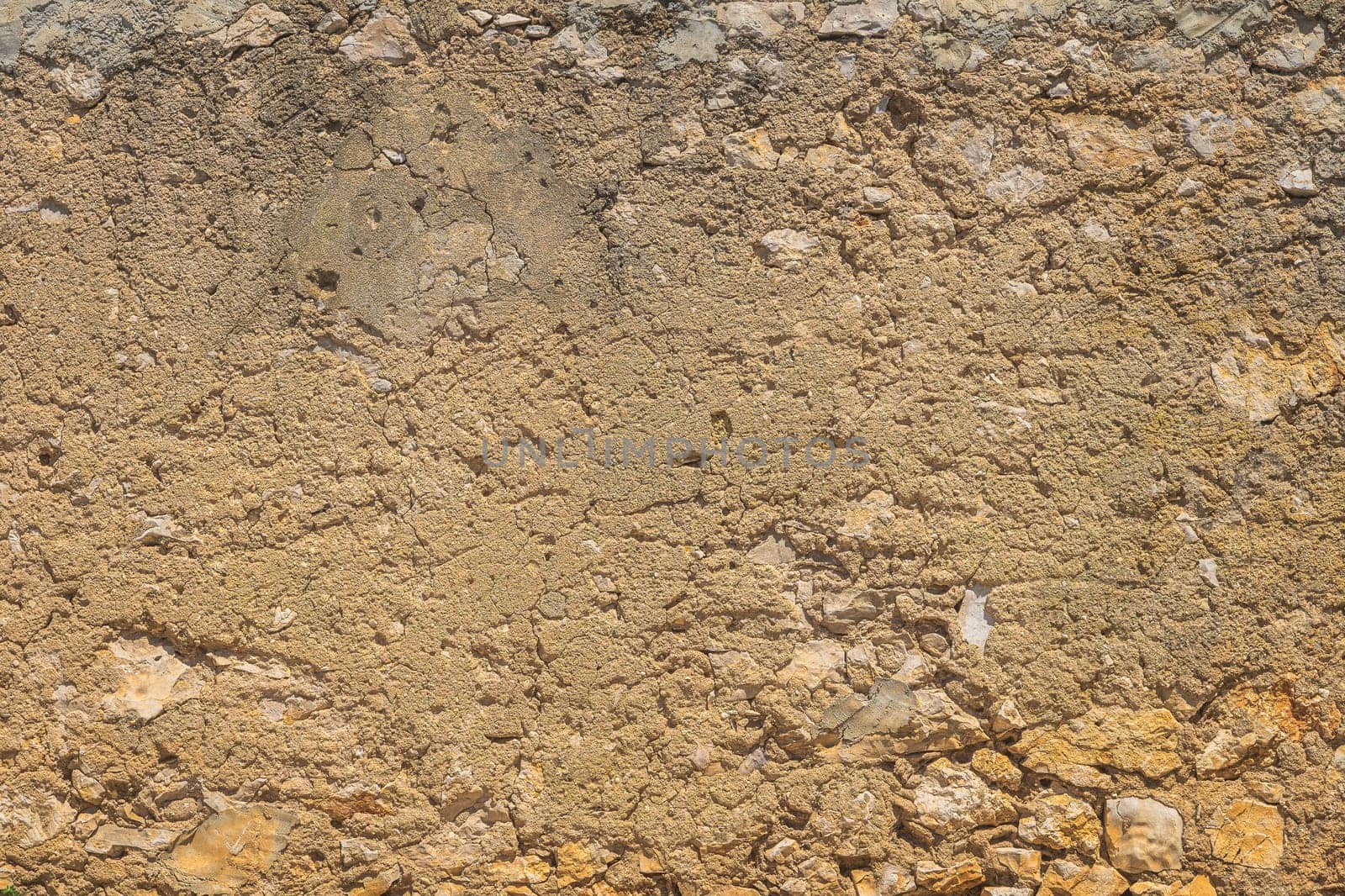 Old, rustic corroded and damaged stone and plaster wall. High quality texture and background for your projects and creative work