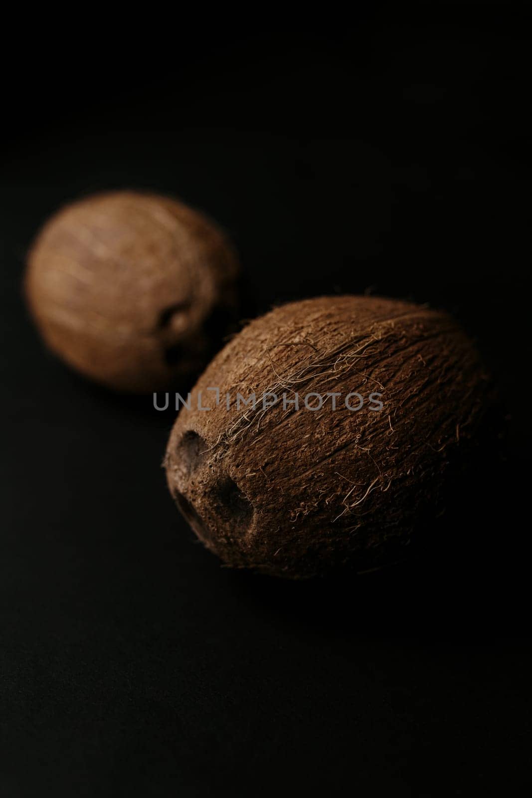 Raw coconut on the black background. Blurred background. High quality photo
