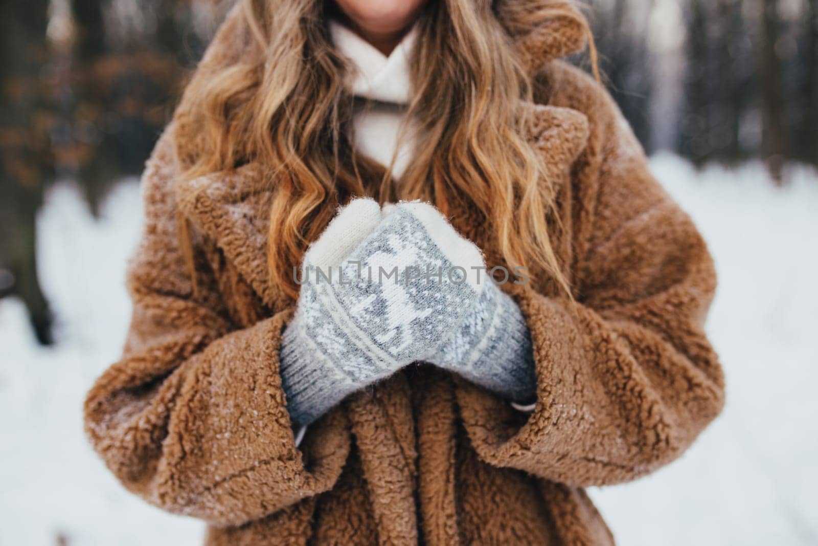 Young woman in fur coat, gloves and scarf in snowy forest. High quality photo