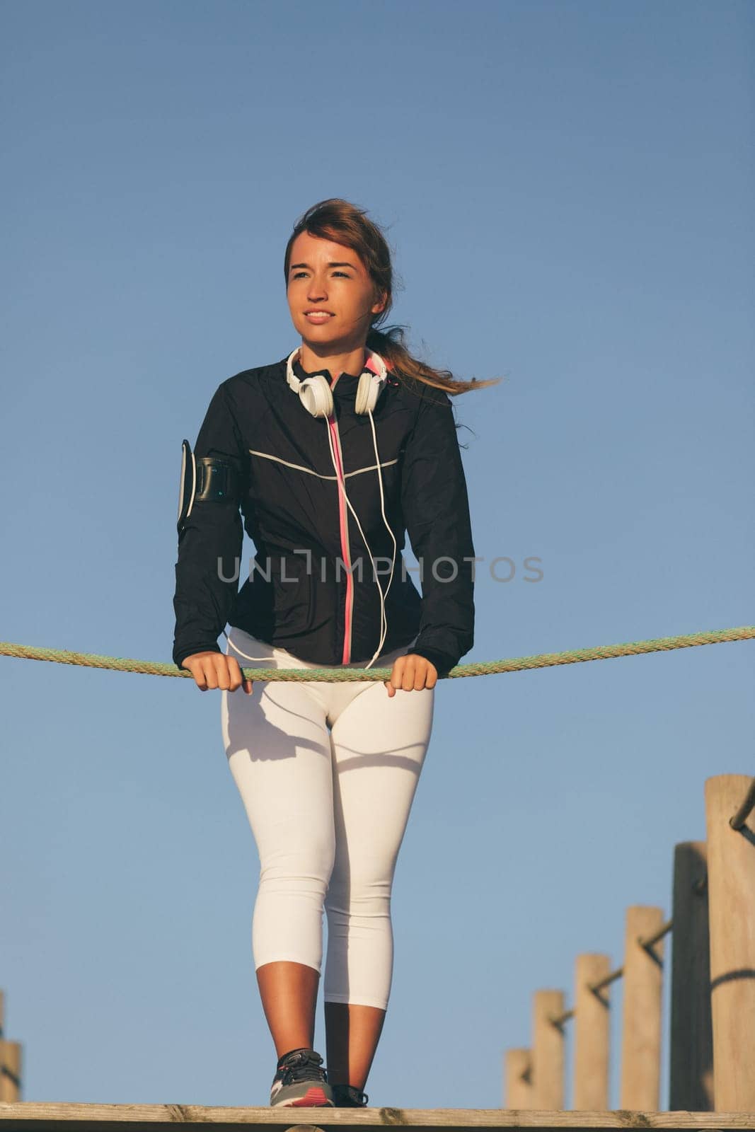 Young beautiful chinese woman exercising at the beach at sunrise/sunset