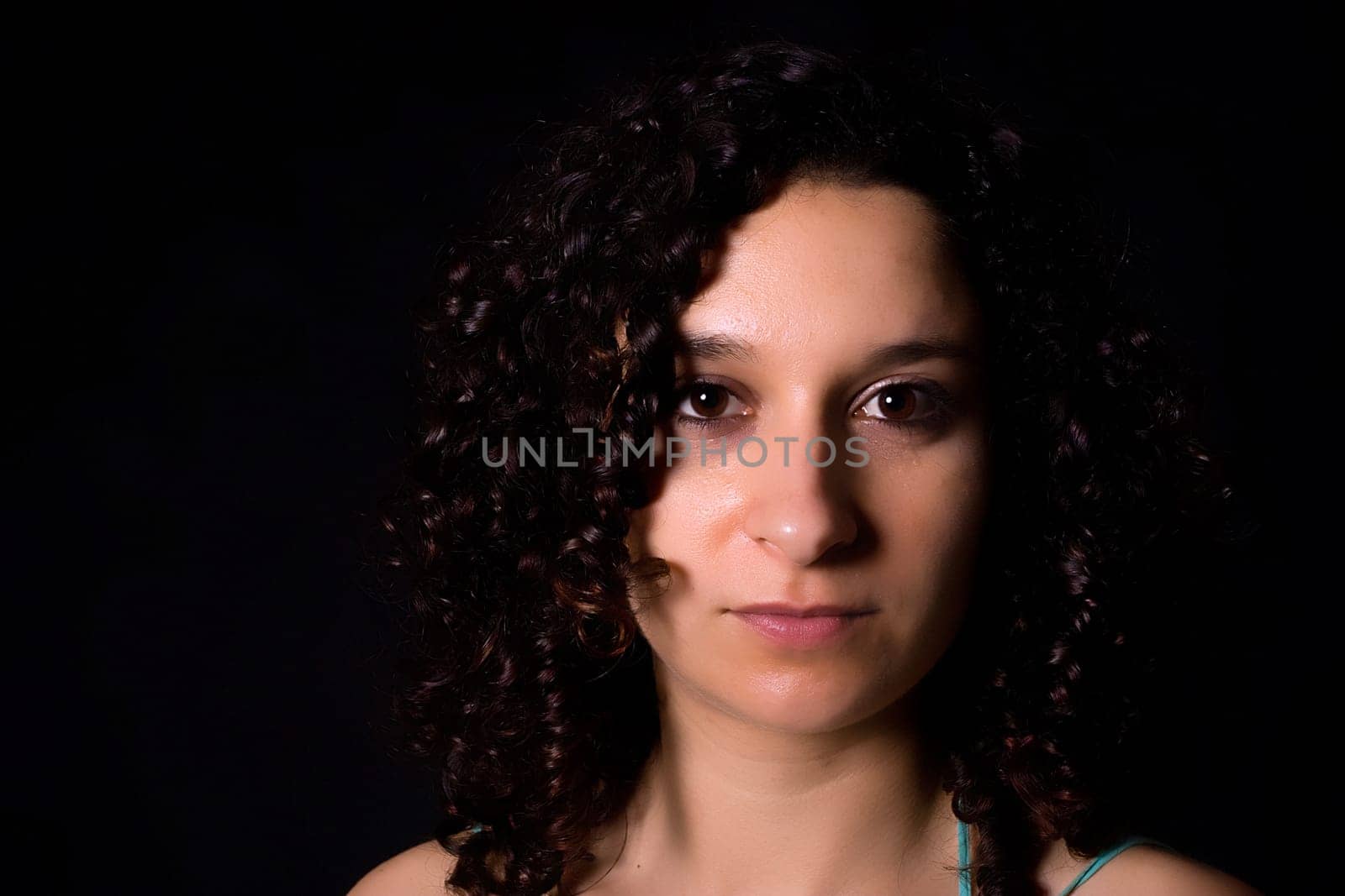 Young girl low key portrait - isolated on black