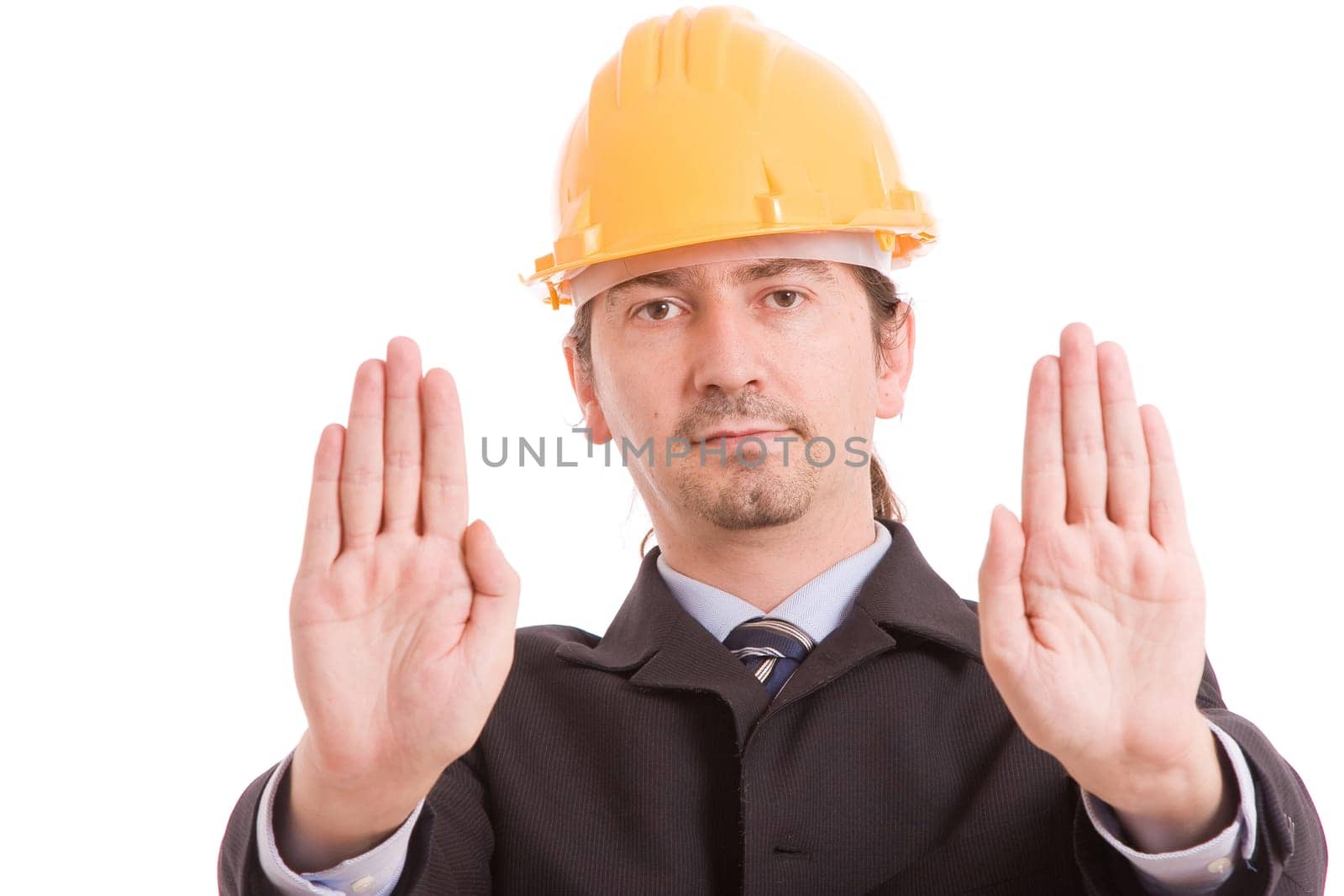 Engineer with yellow hat making stop sign