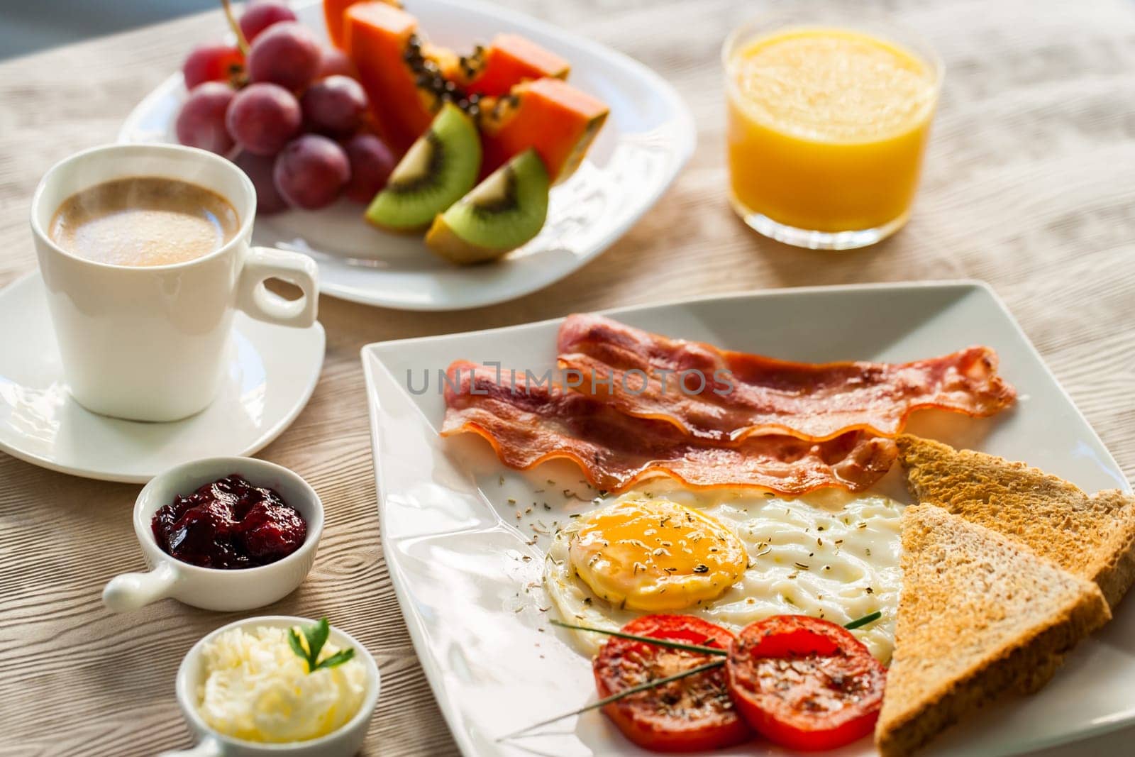 Close up of english breakfast with fresh fruit and coffee.