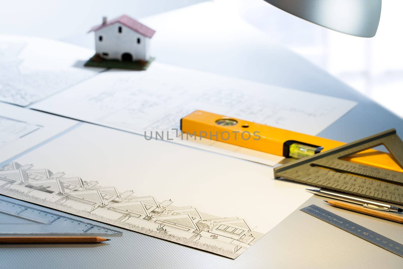 Detail of architect desk with technical drawings and measuring tools.