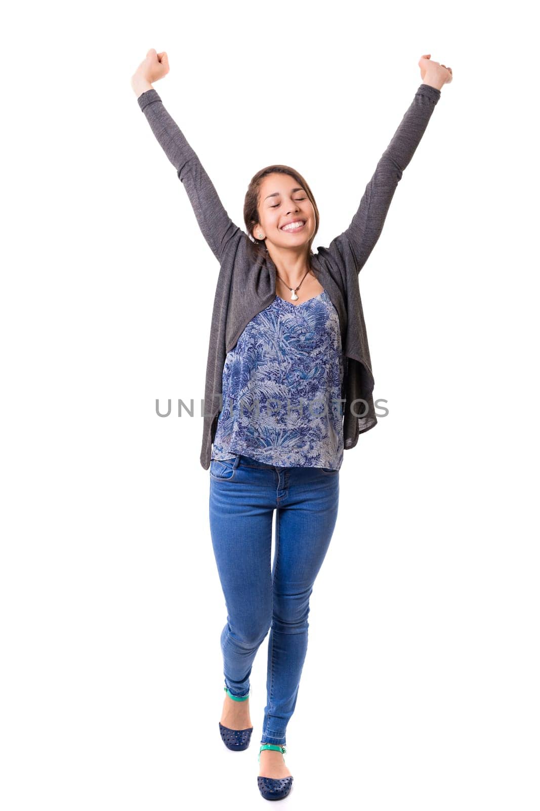 Studio shot: Happy woman with raised arms