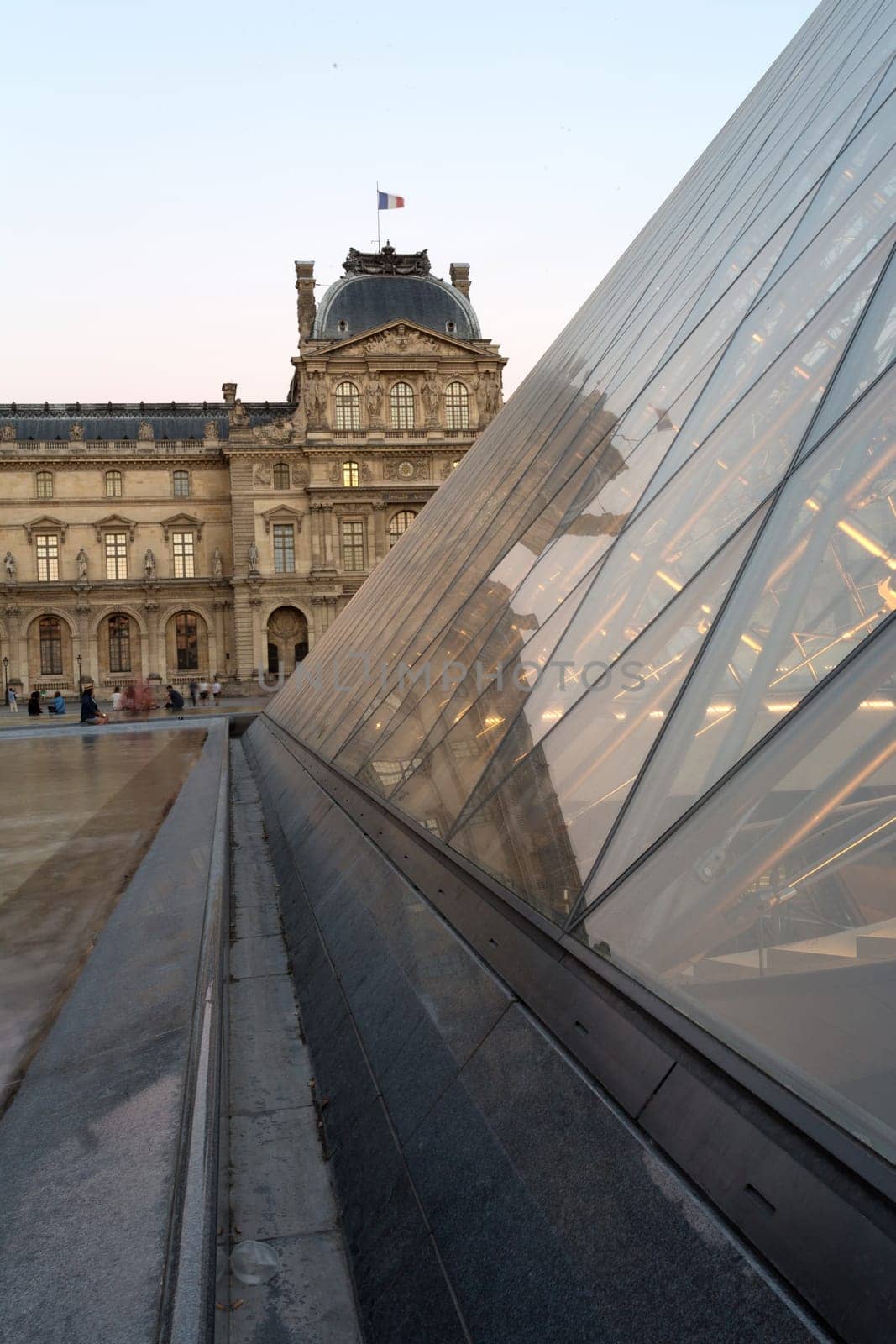 PARIS - AUGUST 15, 2016 Louvre museum at twilight in summer. Louvre Museum is one of the world's largest museums, every year museum visits are more than 8 million visitors.