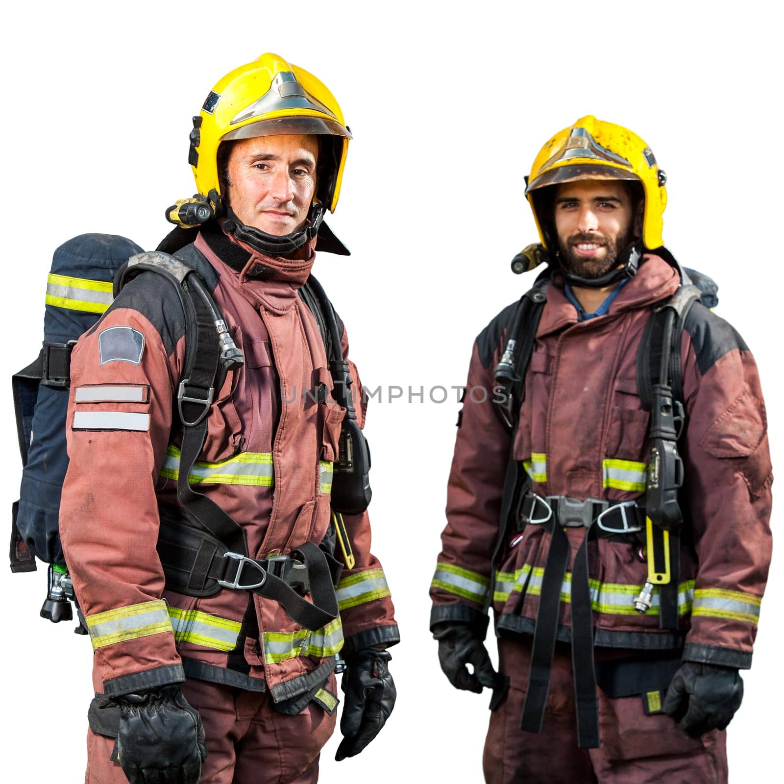 Two firemen wearing official fire fighting uniforms isolated on white background..