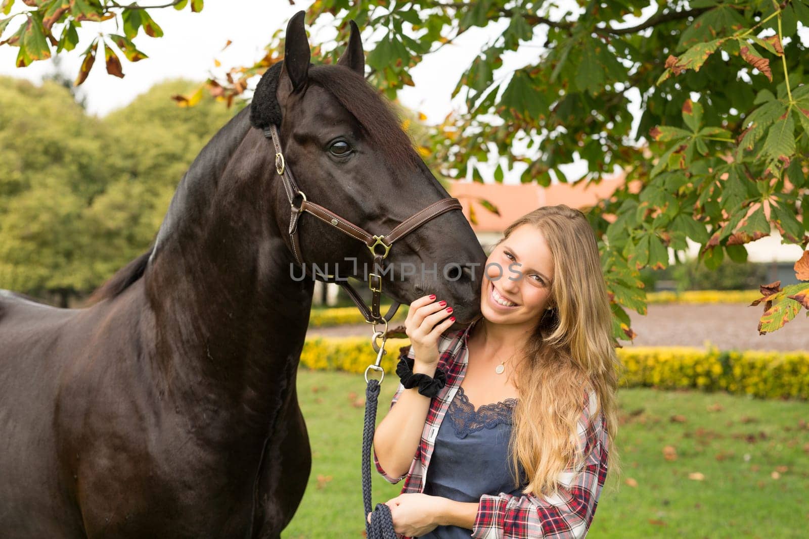 Beautiful and natural young woman spending sometime with her horse