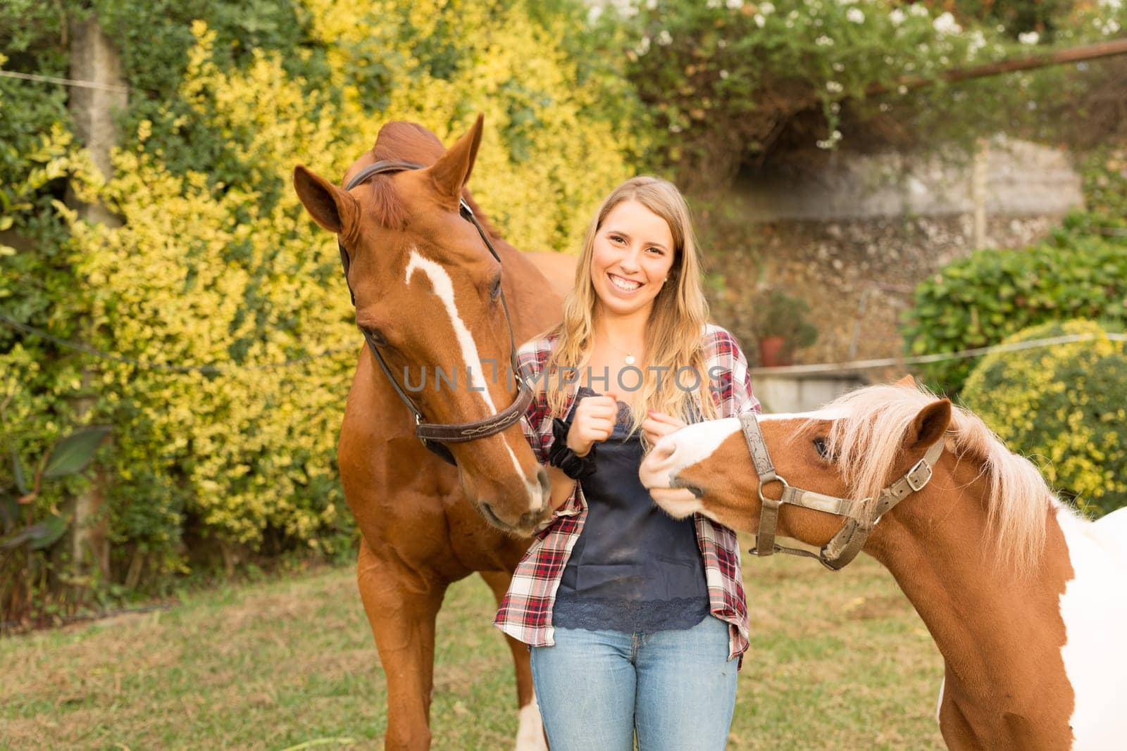 Beautiful and natural young woman spending sometime with her horse