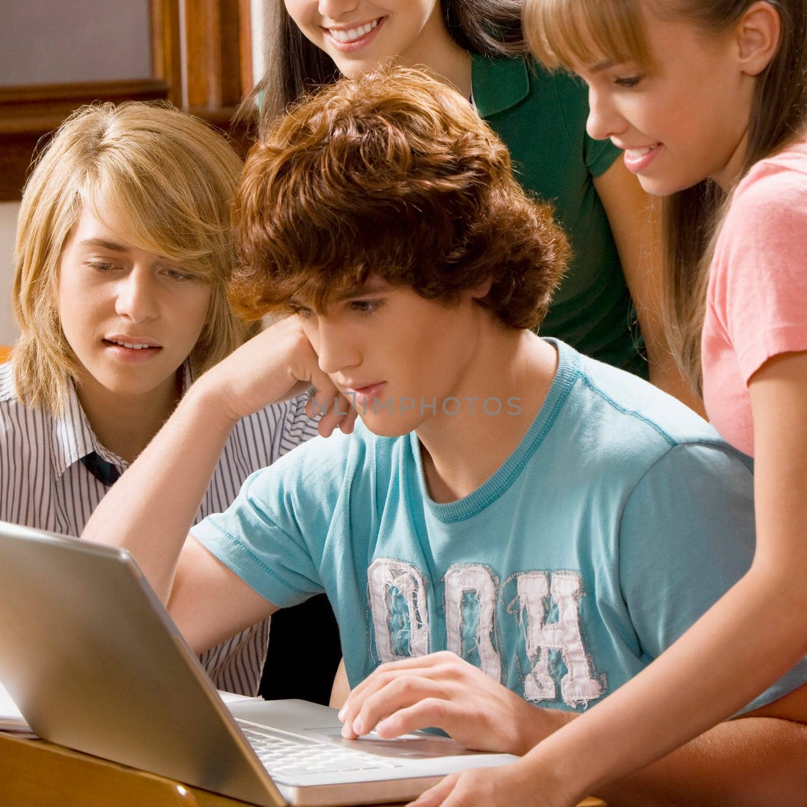 Students using a laptop in the classroom