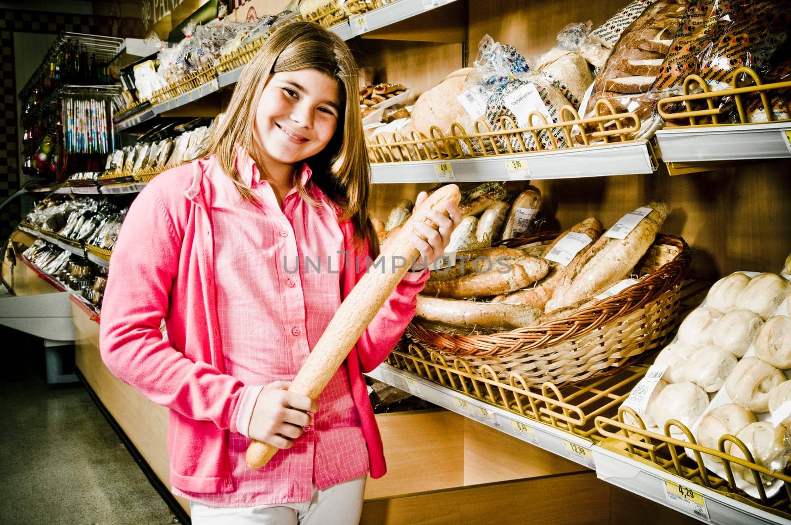 Girl holding a loaf of bread in a supermarket