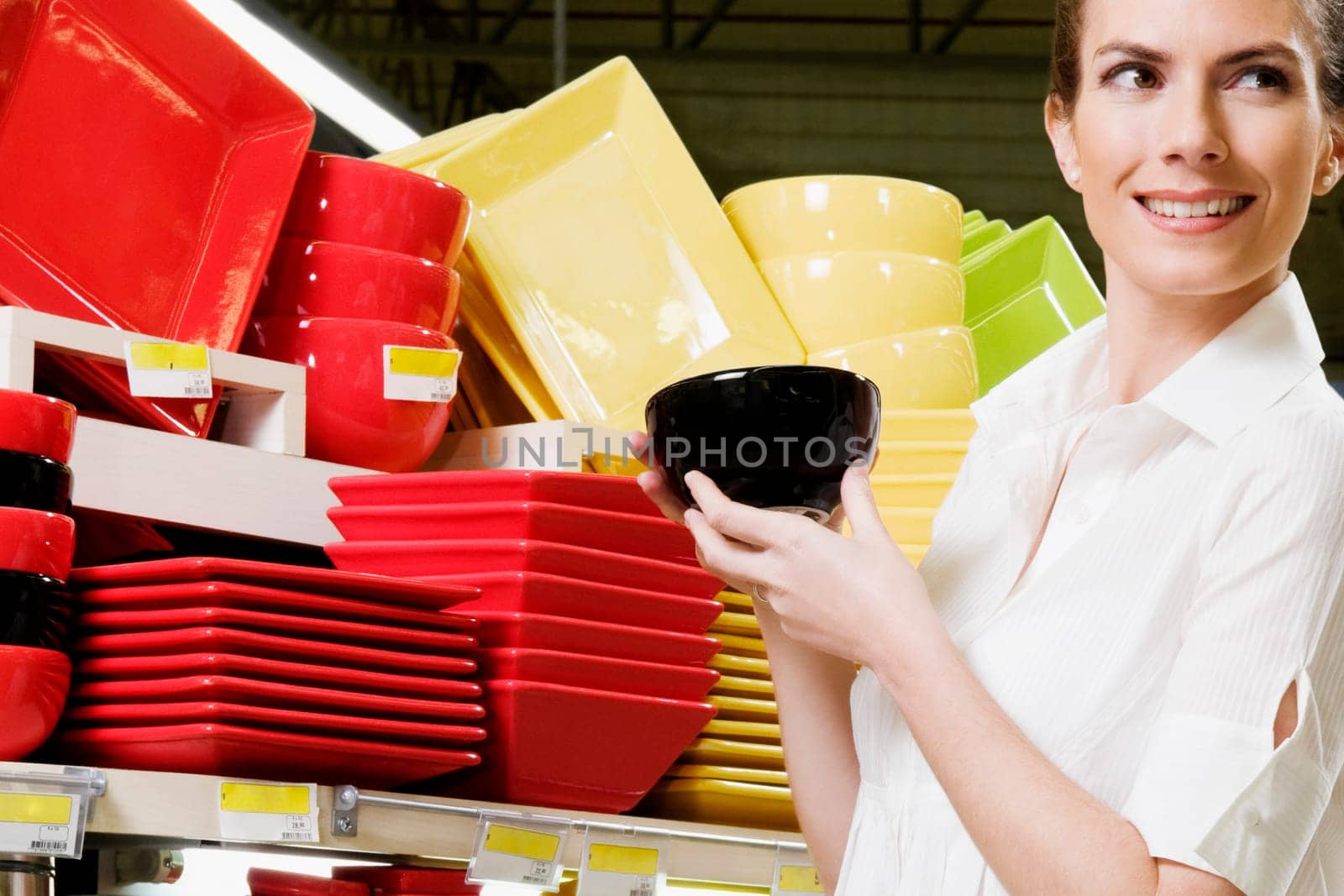 Woman buying crockery in a supermarket