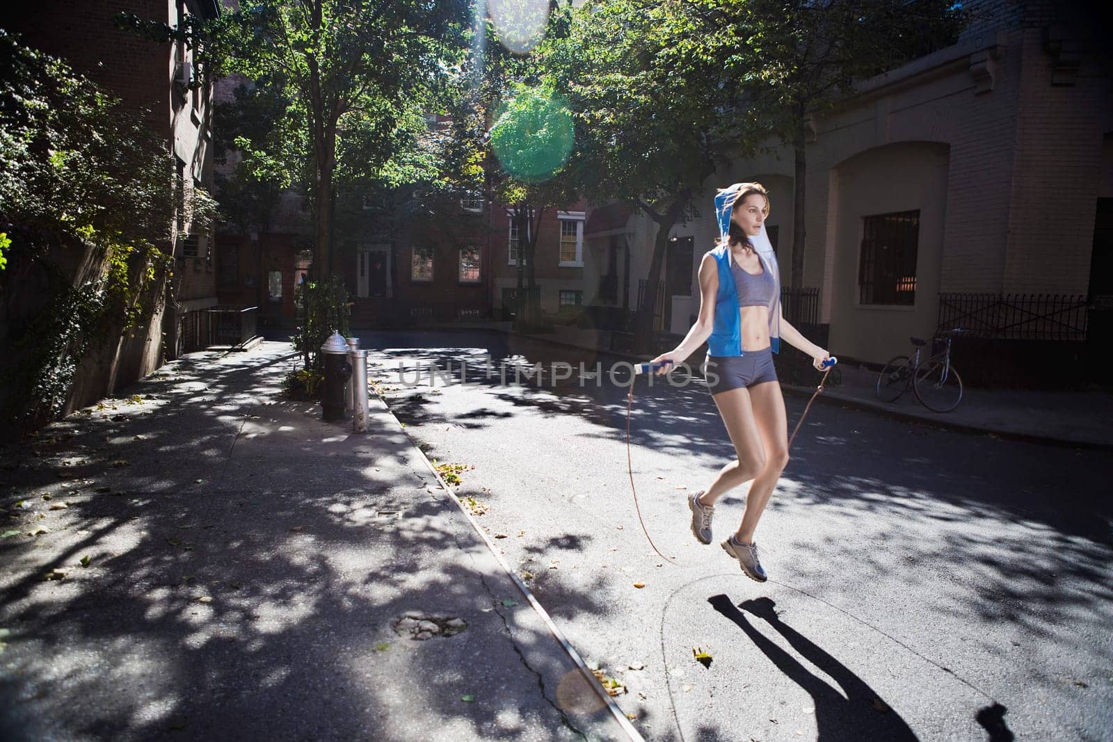 Woman jumping with a rope in the street