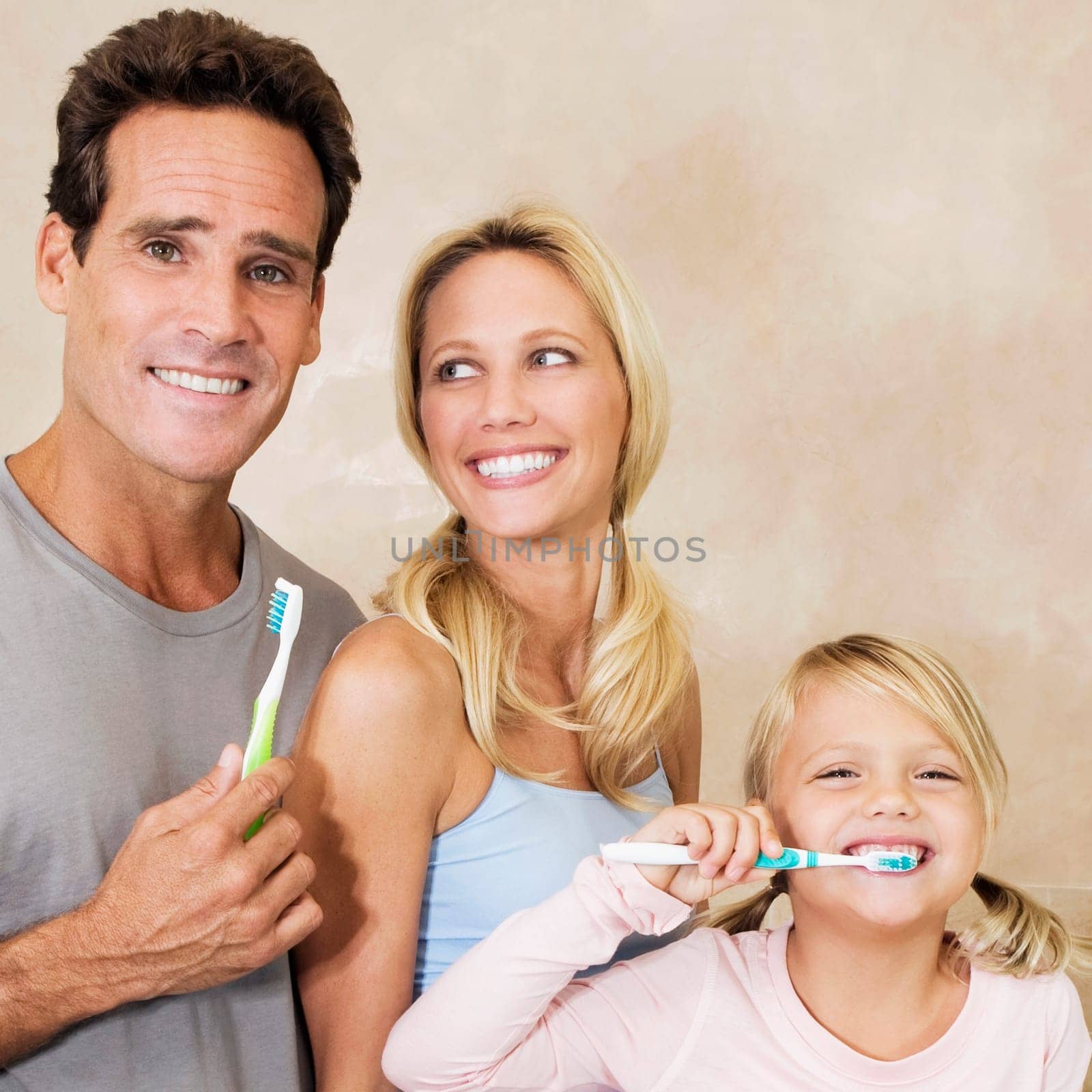 Family brushing teeth in the bathroom