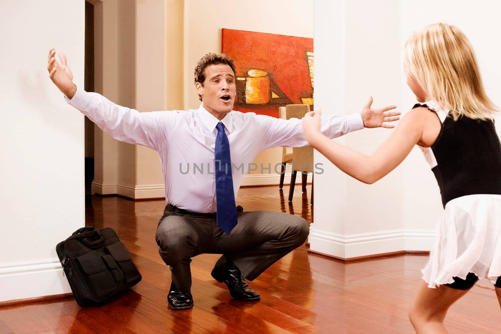 Businessman receiving a warm welcome from his daughter