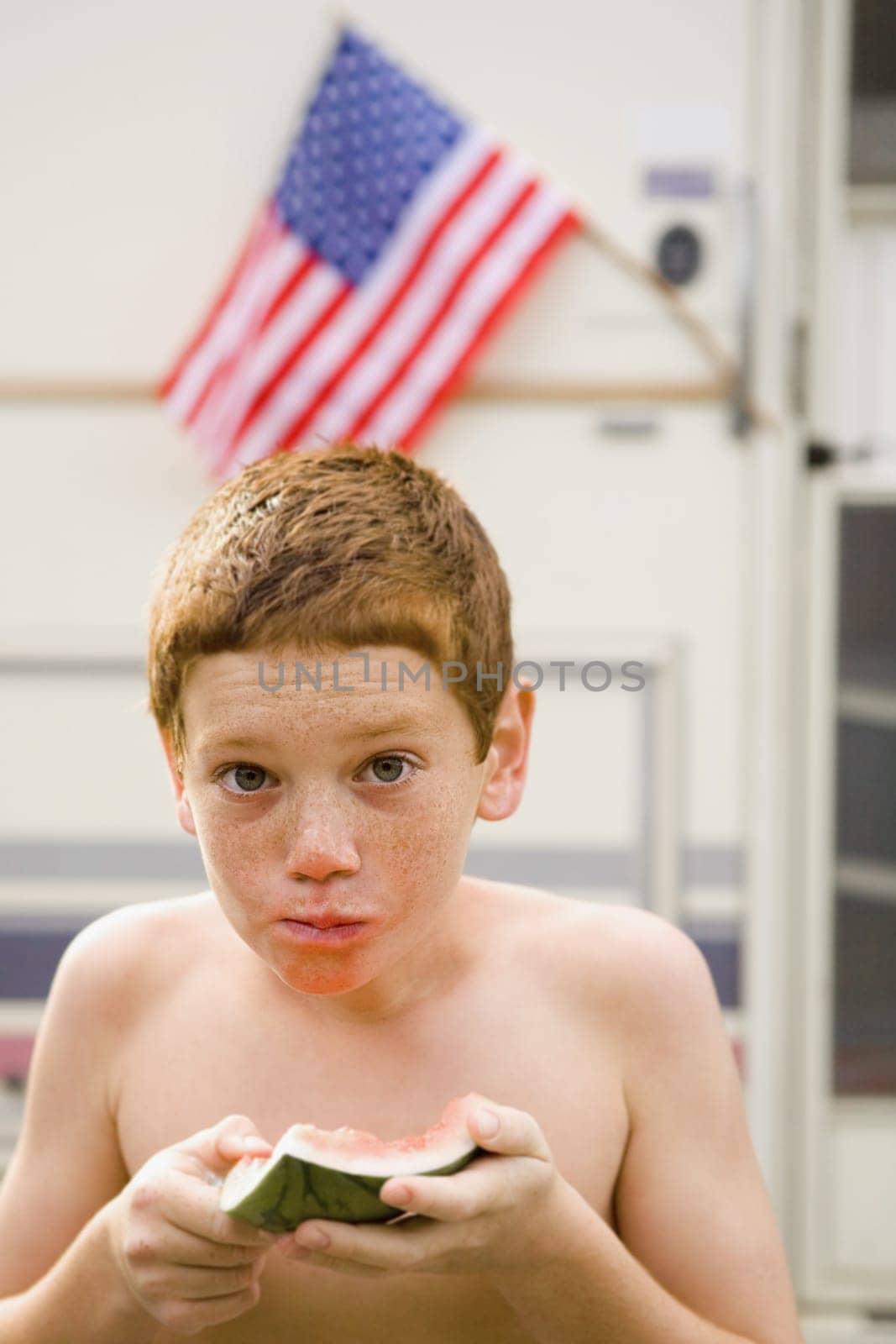 Boy eating a slice of watermelon
