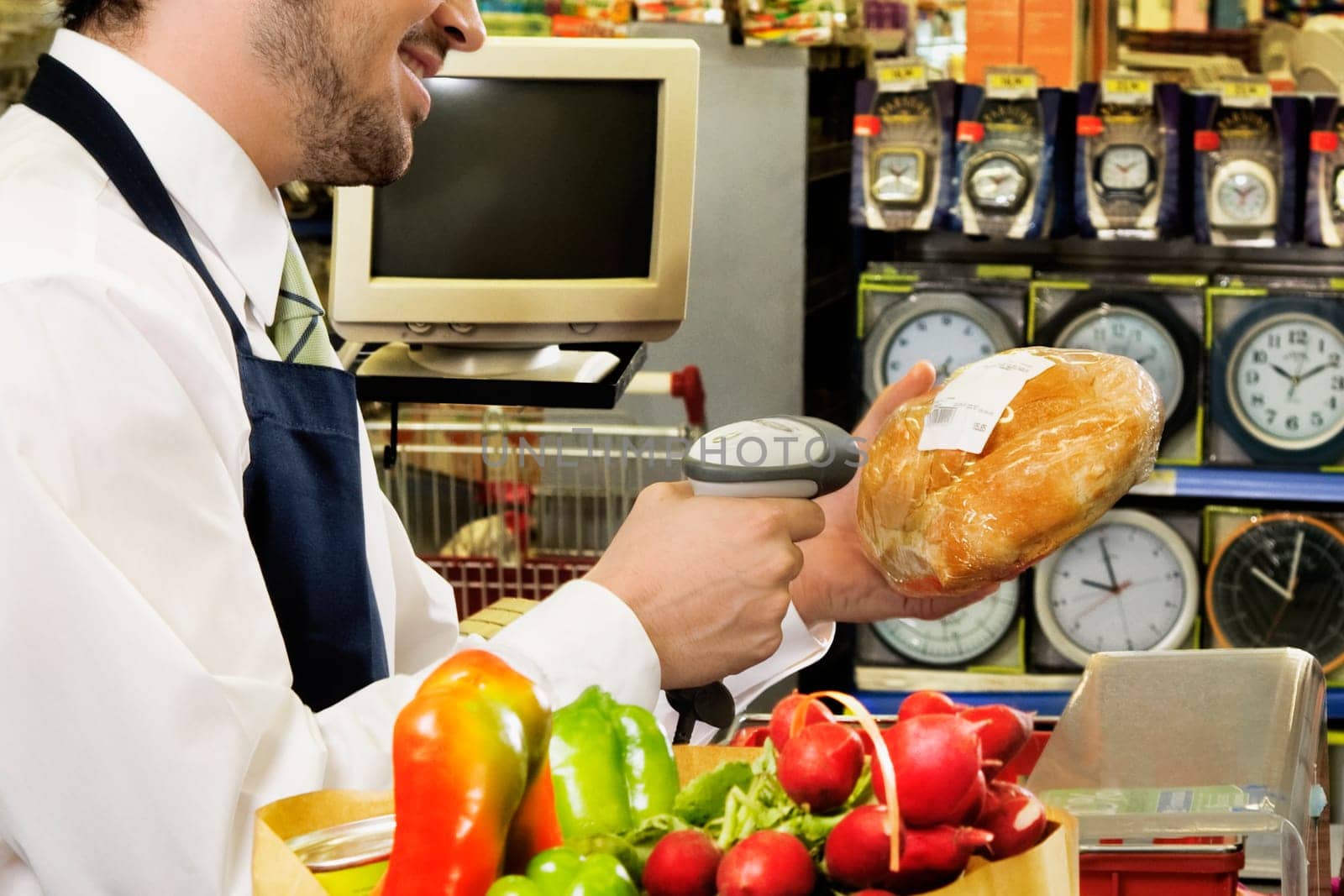 Sales clerk scanning the price of a bread with a bar code reader