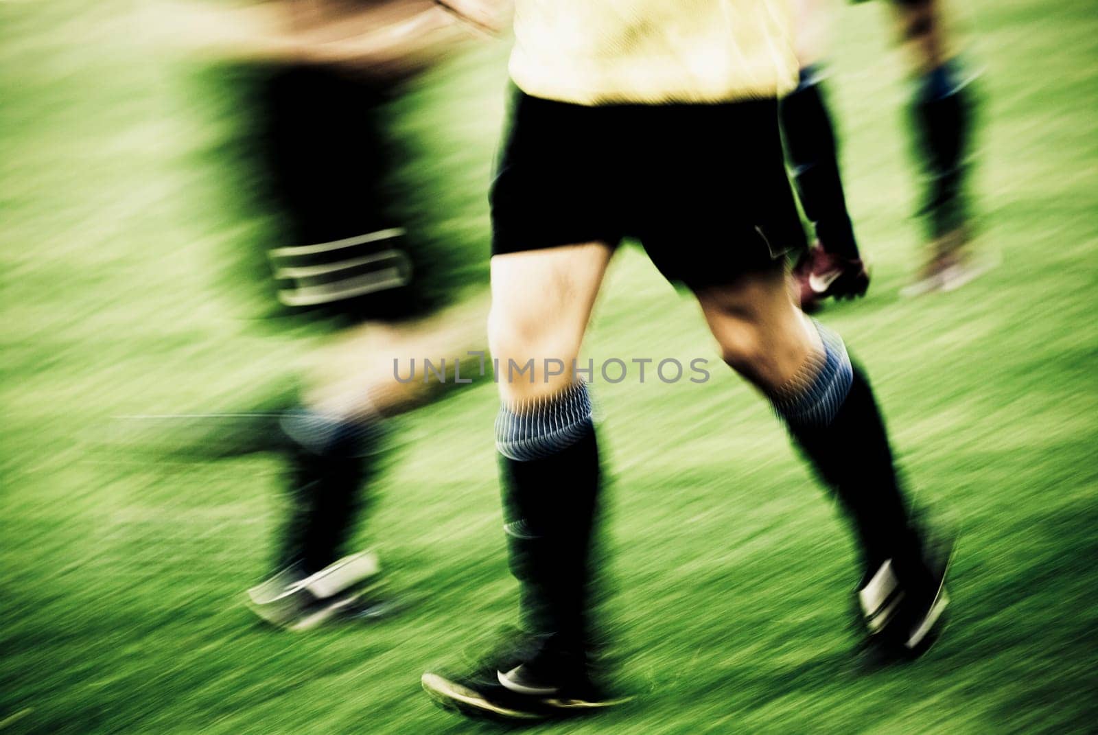 Three soccer players in a field
