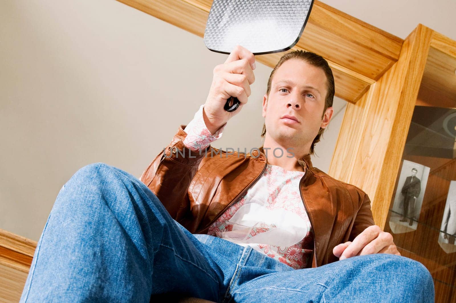 Man looking himself in a mirror after a haircut