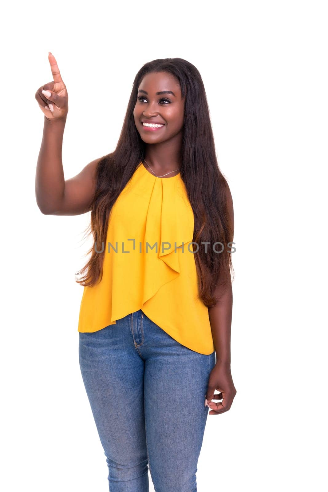 A beautiful african woman pointing to something, isolated over a white background