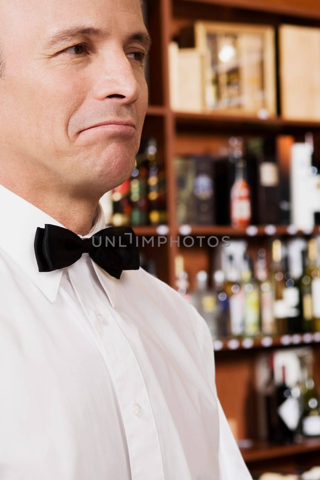 Close_up of a waiter looking displeased
