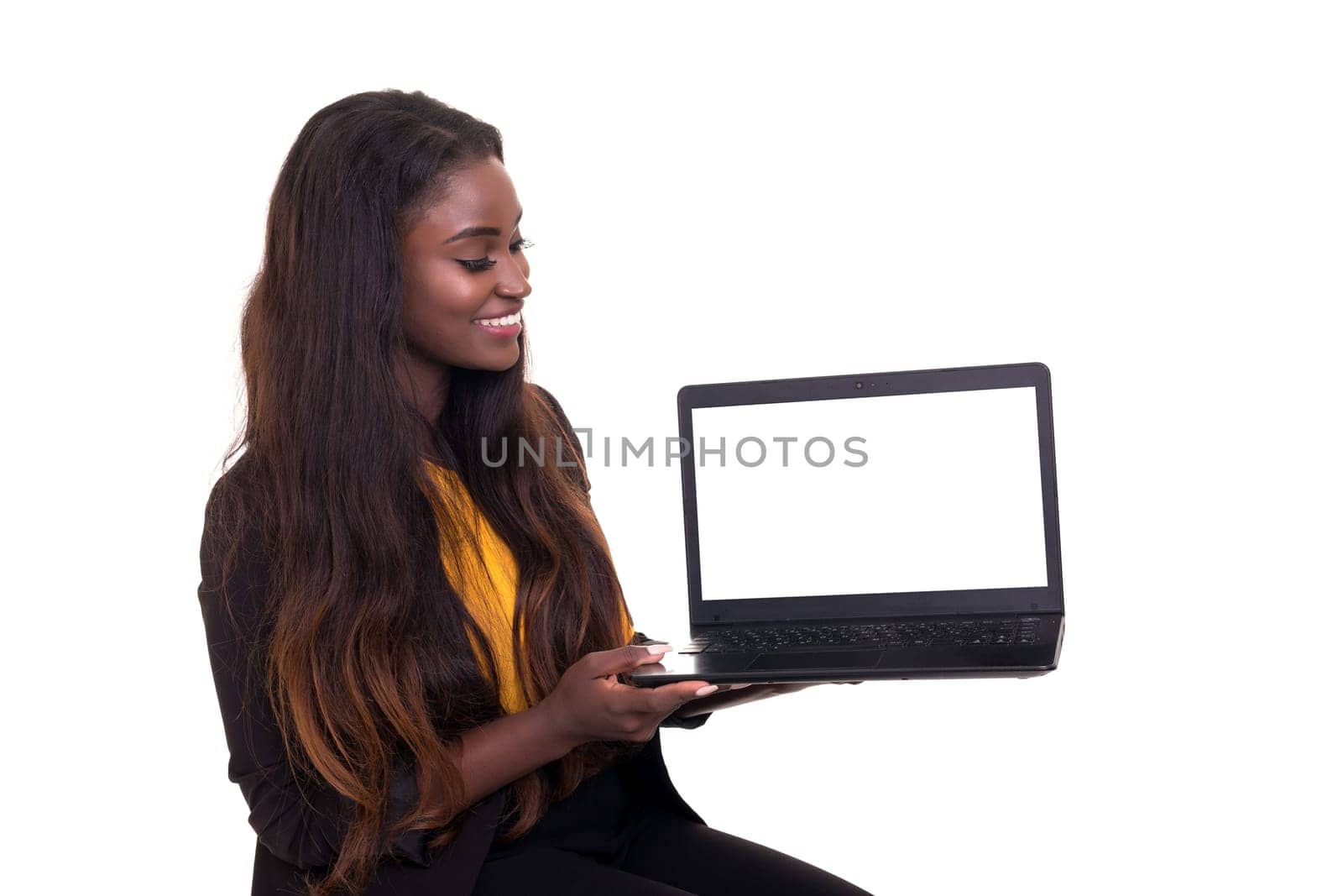Young african woman presenting your product on a laptop computer