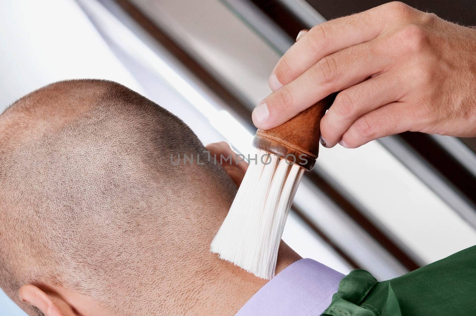 Barber using a brush on a manŽs neck