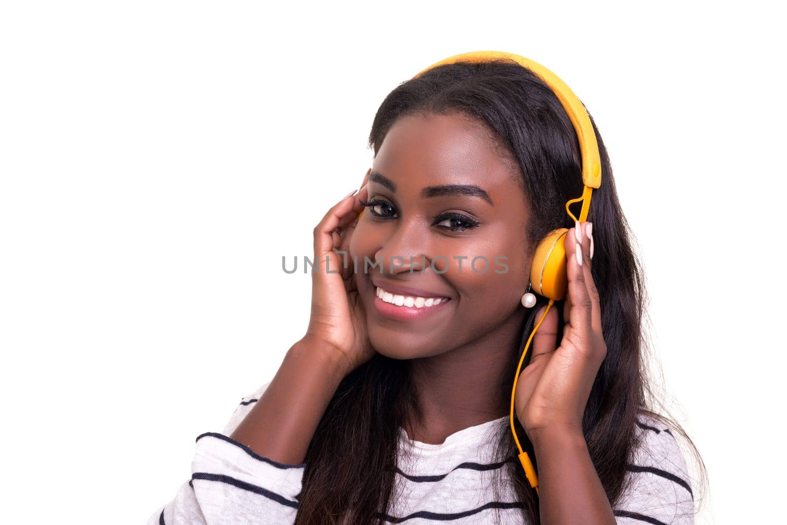 Beautiful young african woman listening to music, isolated over white