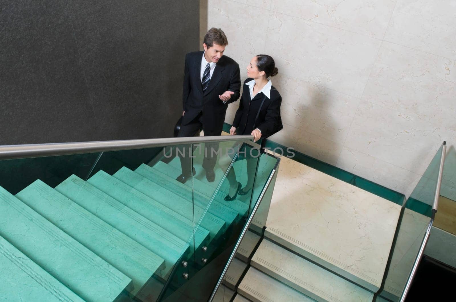 Businessman and a businesswoman moving up stairs