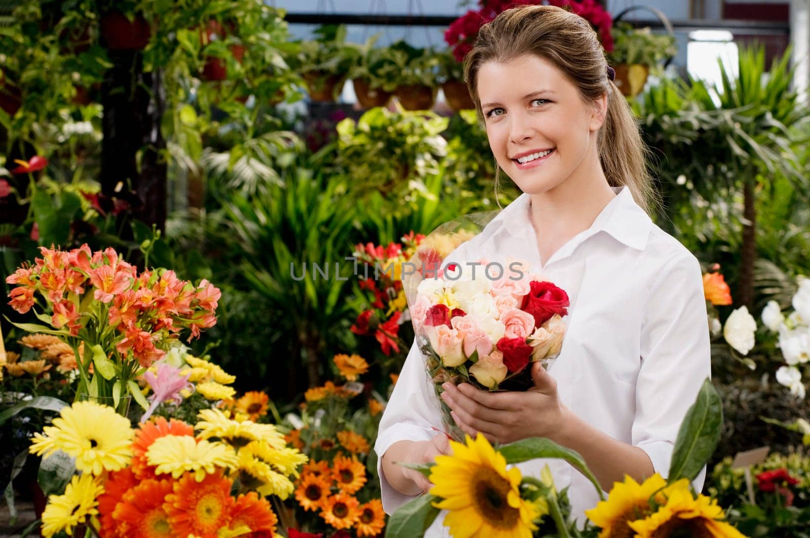 Customer holding a bouquet of flowers and smiling