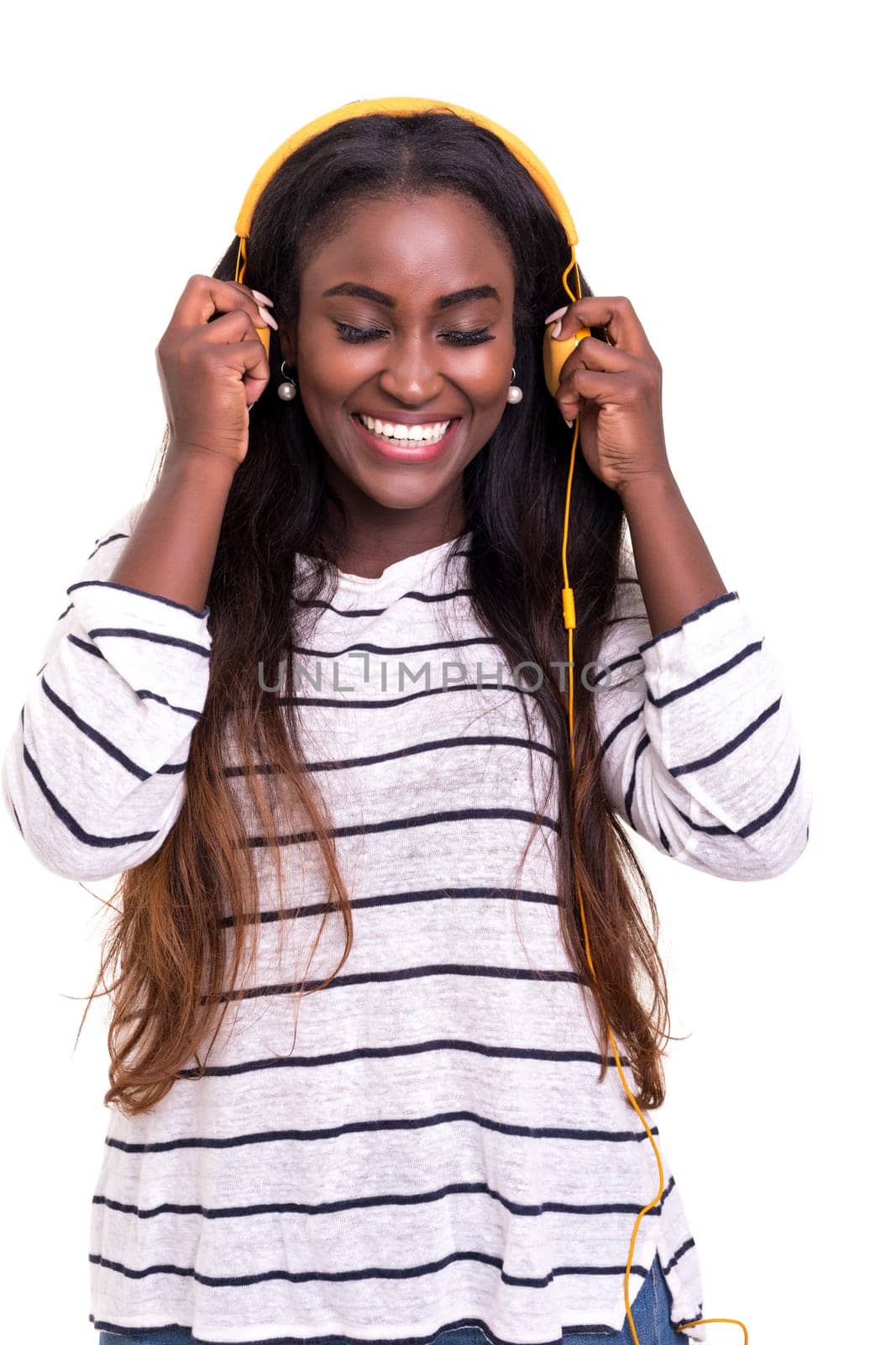 Beautiful young african woman listening to music, isolated over white