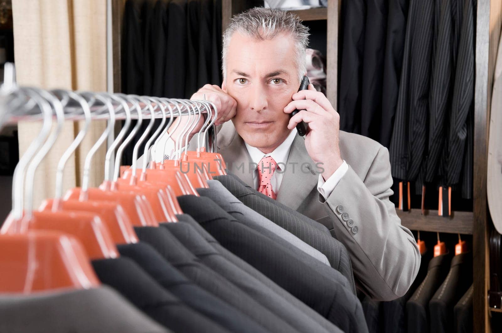 Customer talking on a mobile phone in a clothing store