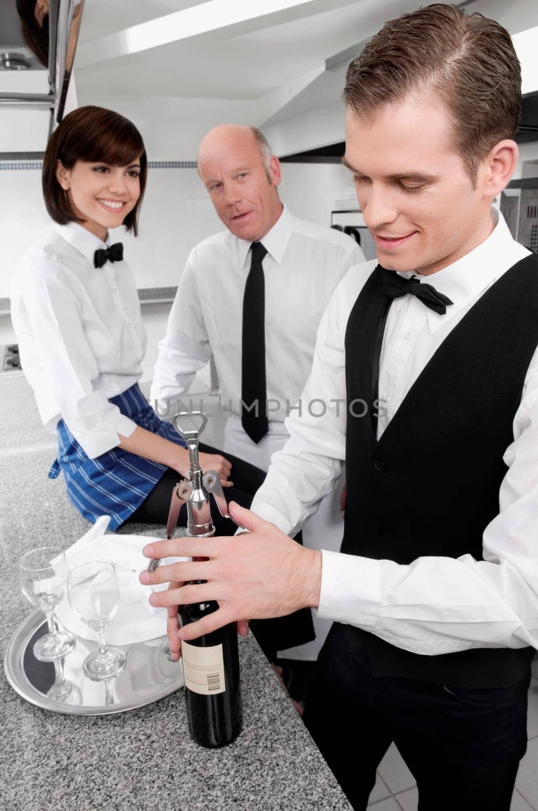 Waiter opening a wine bottle