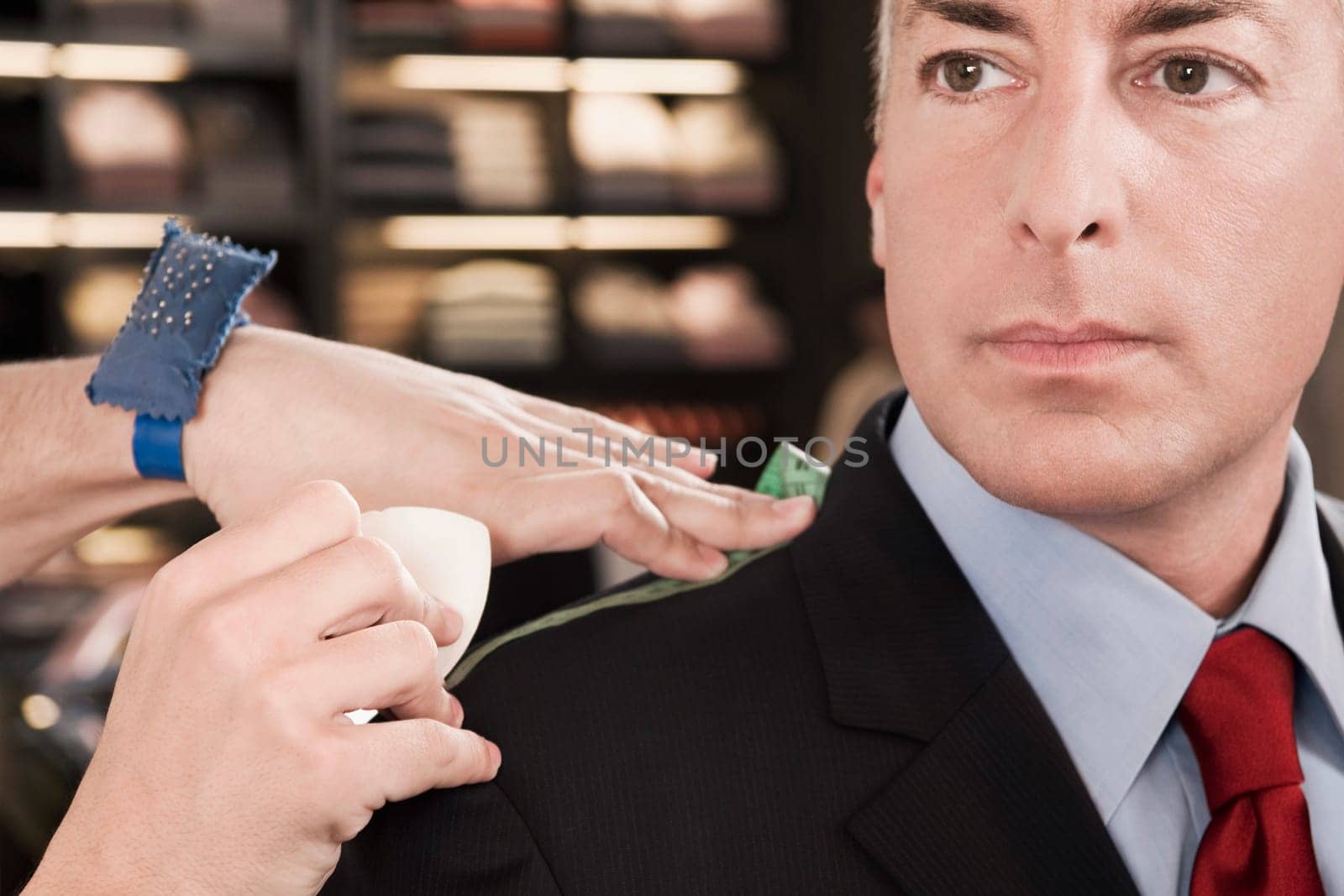 Tailor taking measurement of a businessman