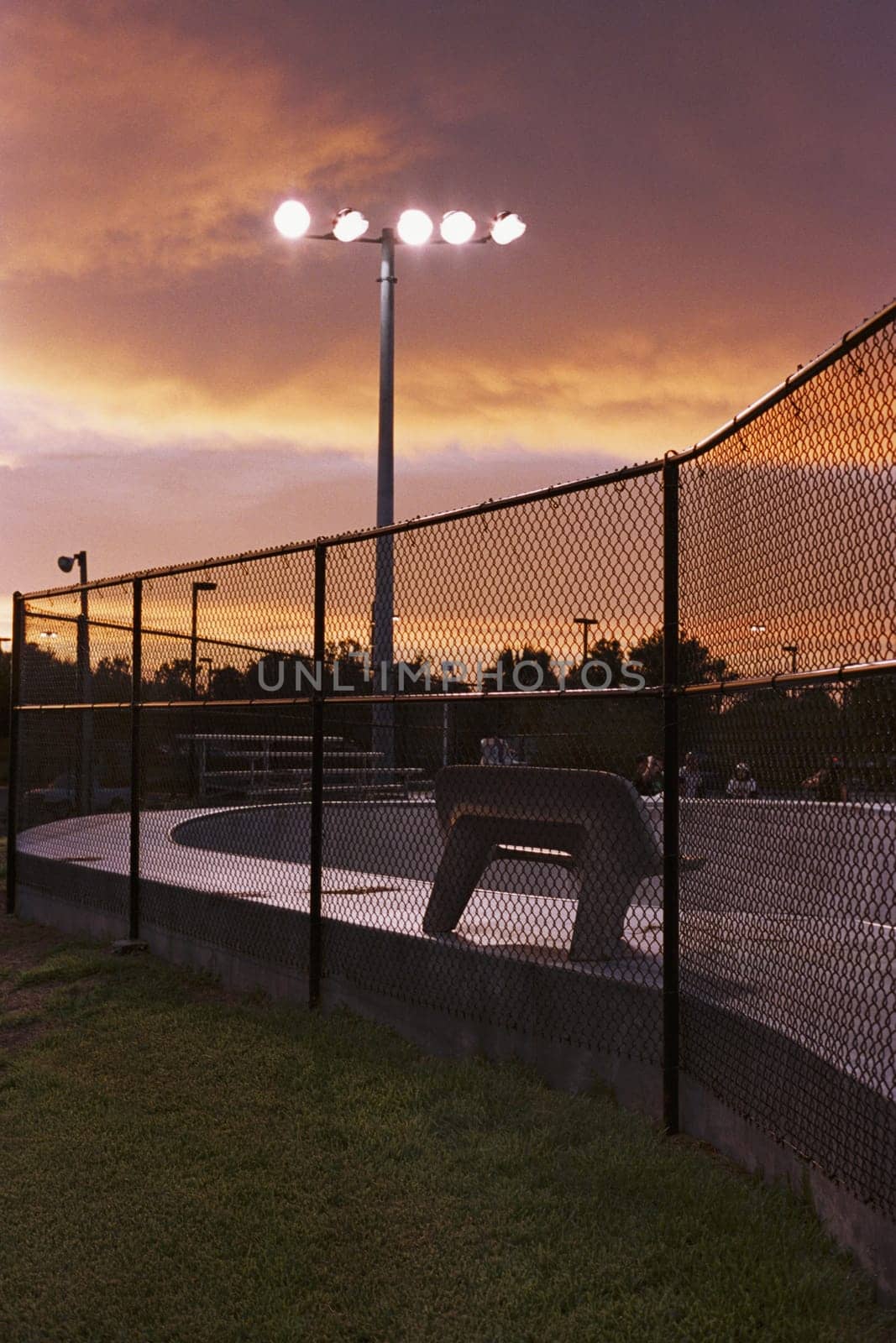 Chainlink fence with a floodlight in a stadium